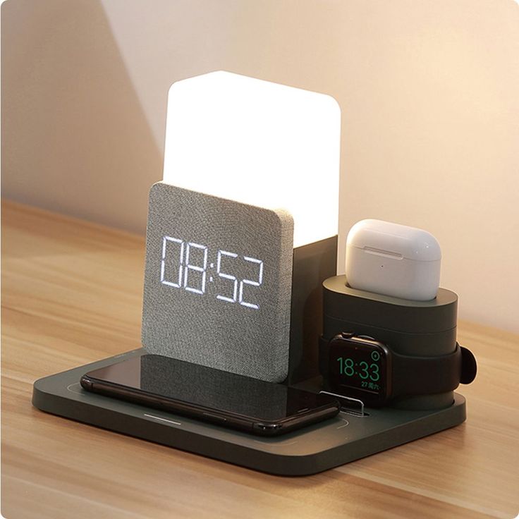 an alarm clock sitting on top of a wooden table