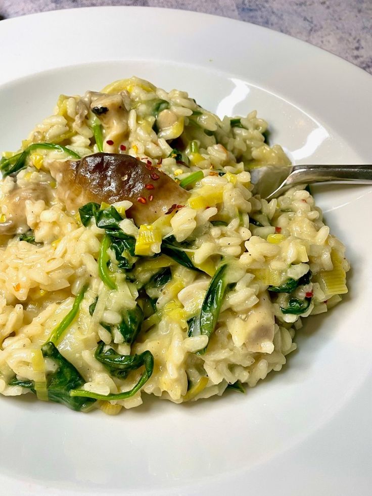 a white plate topped with rice and vegetables