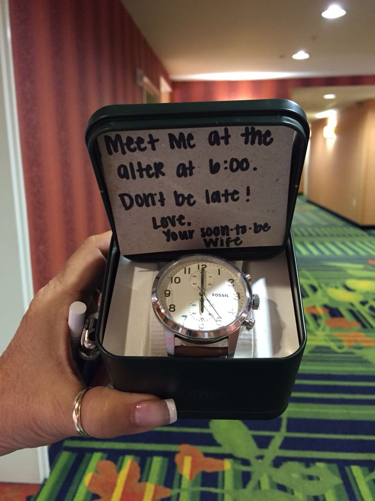 a person holding up a watch in a box that says meet me at the older at b - 00 don't be late