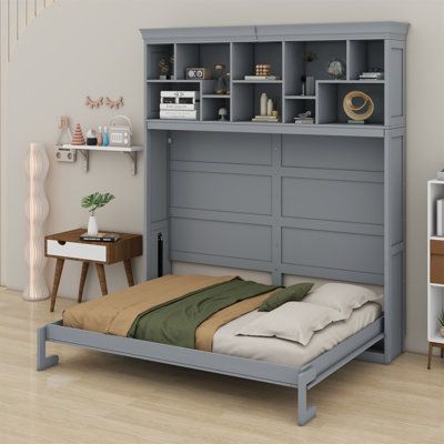 a bedroom with a bed, bookcases and shelves on the wall above it