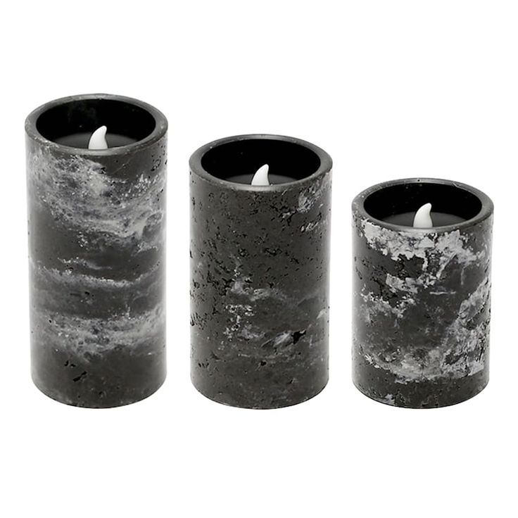 three black candles sitting next to each other