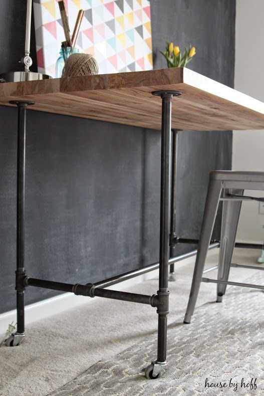 a wooden table sitting on top of a metal frame