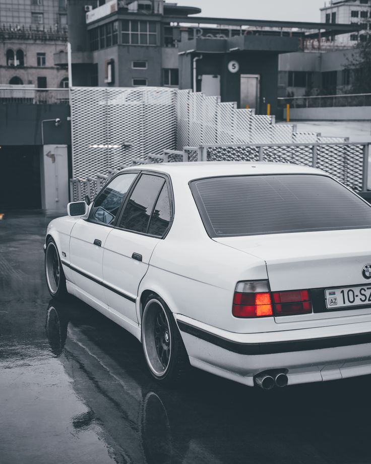 a white car parked in front of a building