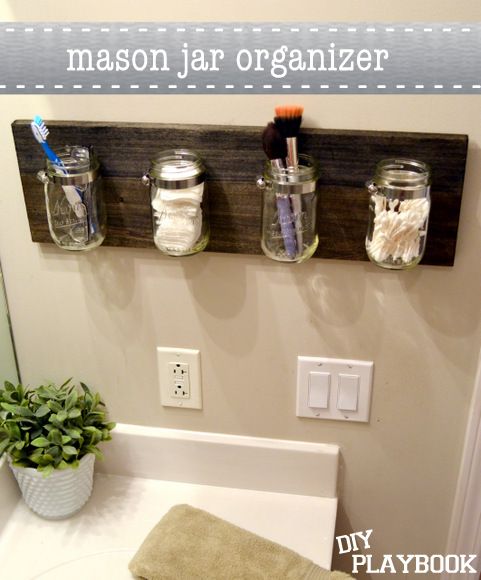 a bathroom with mason jars on the wall