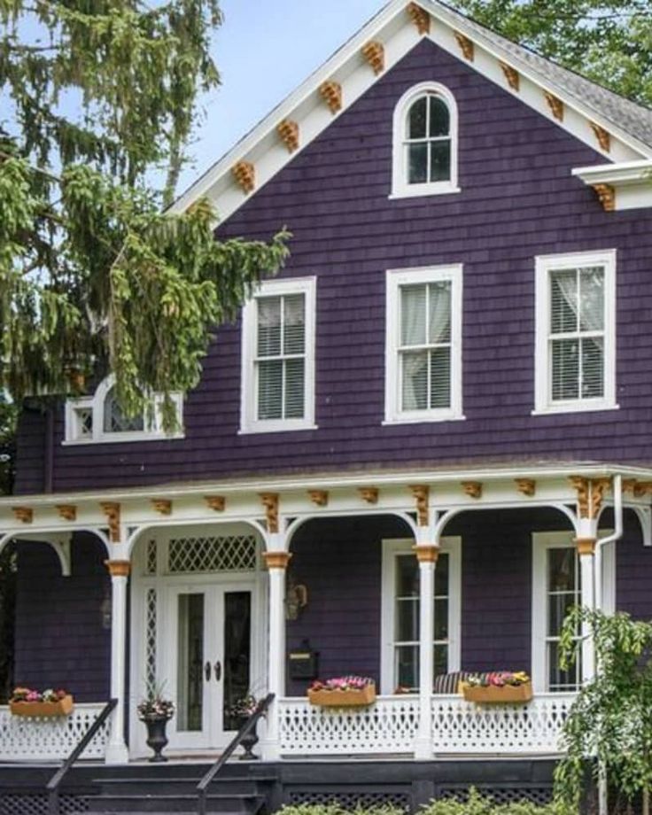 a purple house with white trim and windows