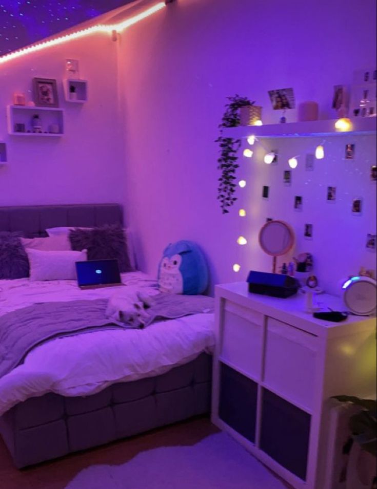 a bedroom with purple lights on the ceiling