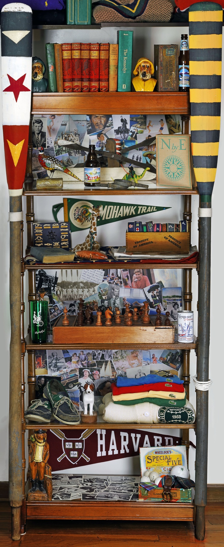 a shelf filled with lots of assorted items on top of a hard wood floor