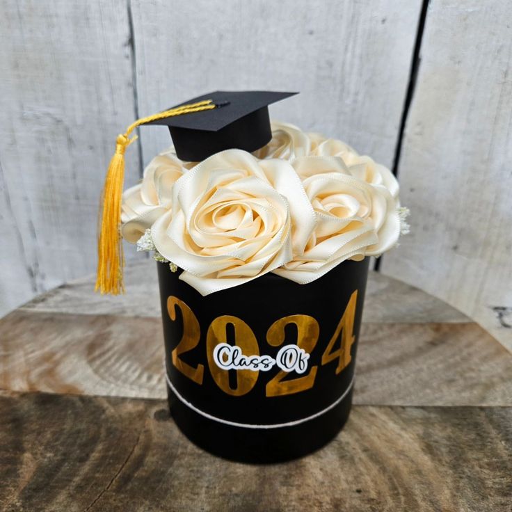 a black graduation hat with white roses in it