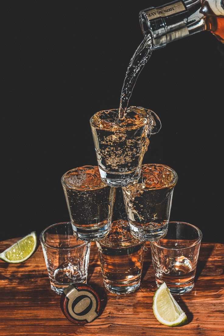 an image of whiskey being poured into glasses