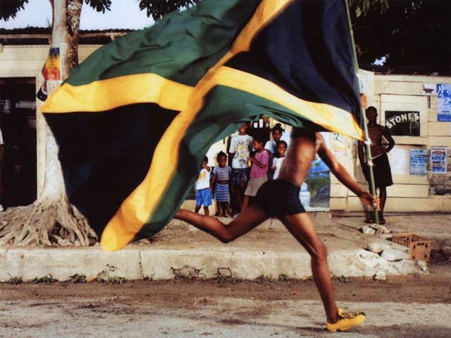 a man running with a flag on his back