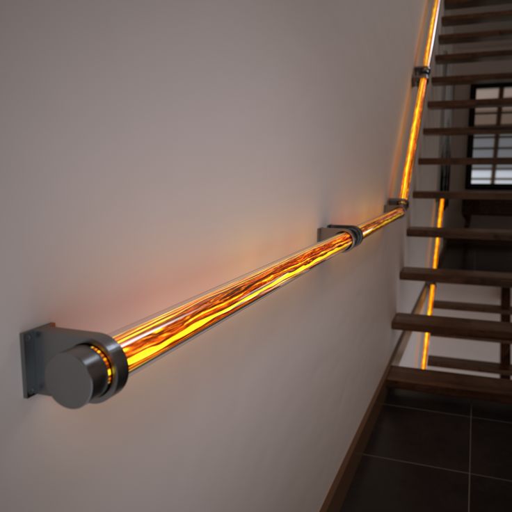 a light that is on the side of a wall next to a stair case in a house