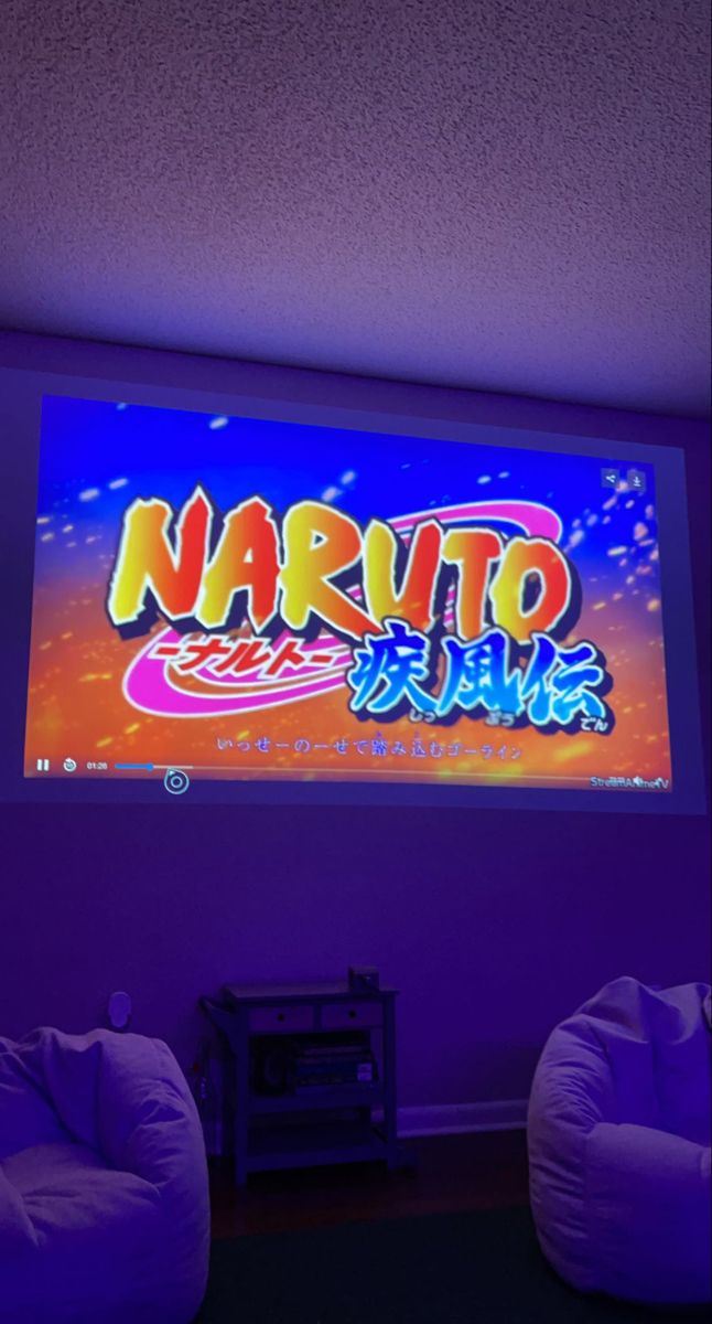 two bean chairs in front of a large screen with the word naruto on it