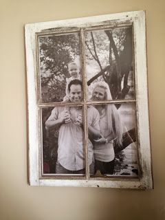 an old window with four photos hanging on it's side in a room next to a wall