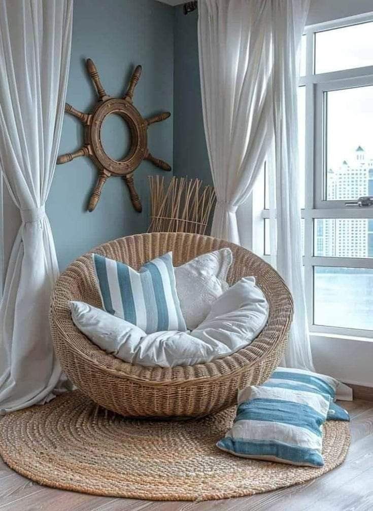 a wicker chair sitting on top of a wooden floor next to a large window