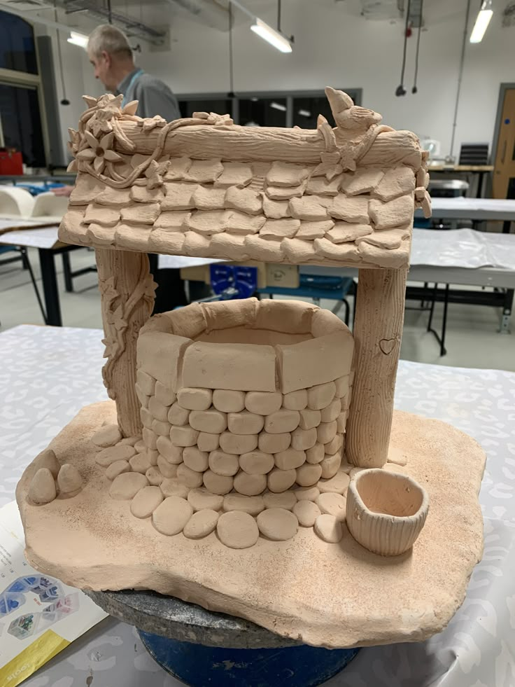 a clay model of a stone oven on a table