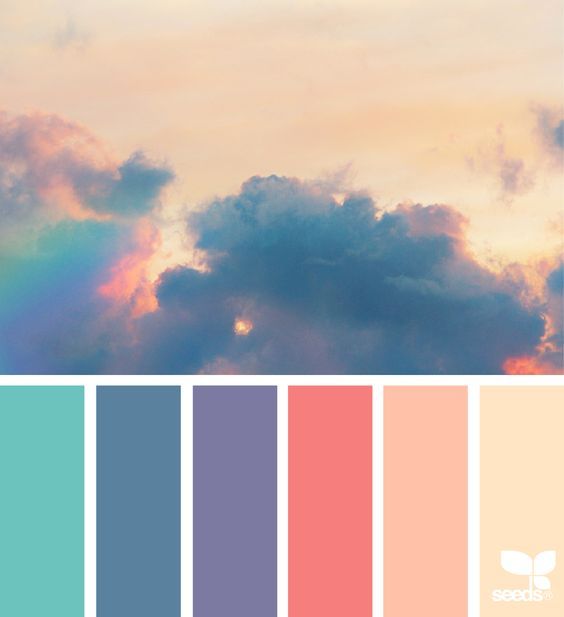 the sky is filled with clouds and colors that are pink, blue, green, yellow, and orange