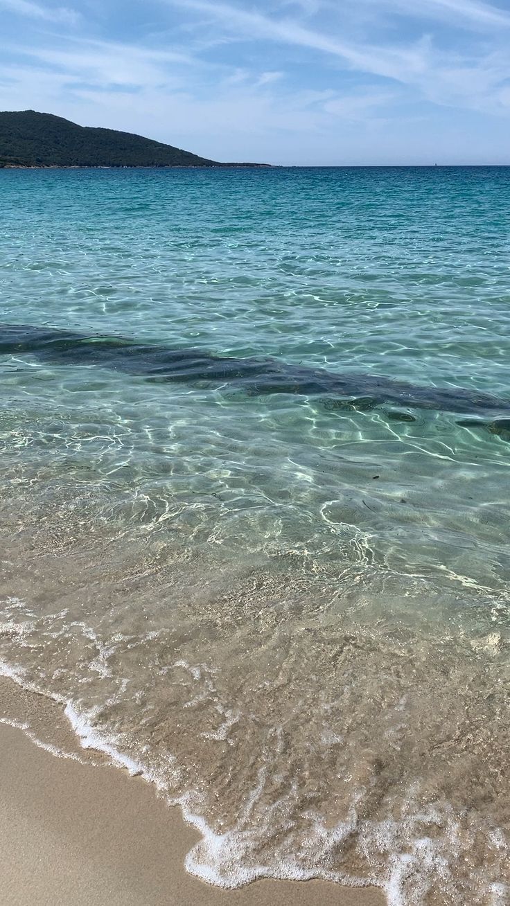 the water is so clear that it appears to be crystal blue and has waves coming in