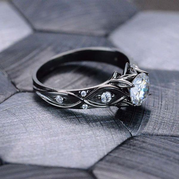 a diamond ring sitting on top of a piece of wood with diamonds in the middle