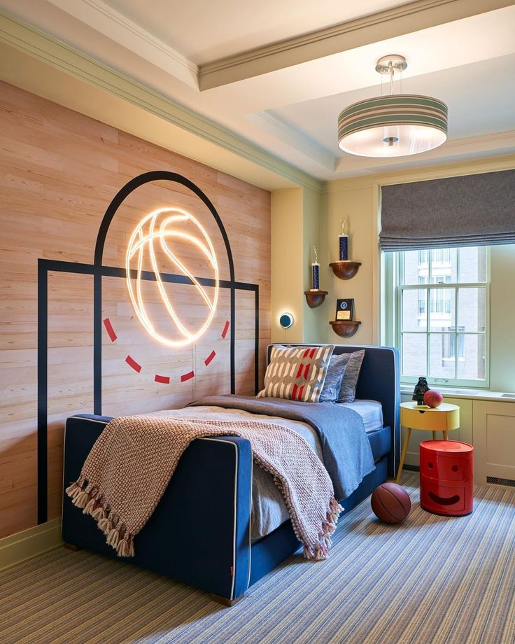 a bed room with a neatly made bed and a basketball on the wall