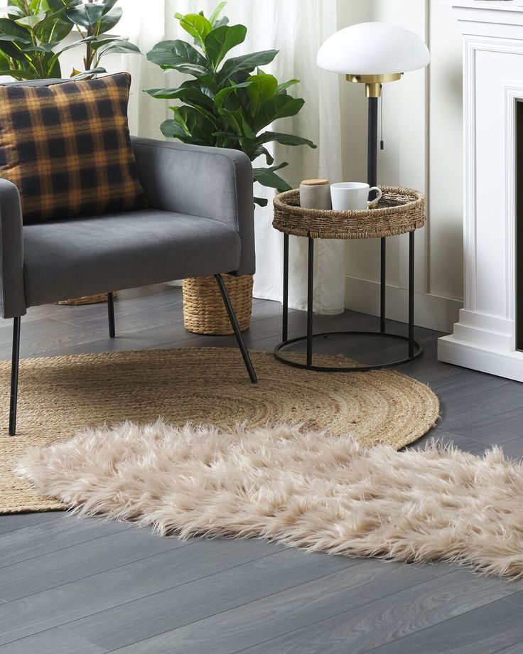 a living room with two chairs and a rug on the floor