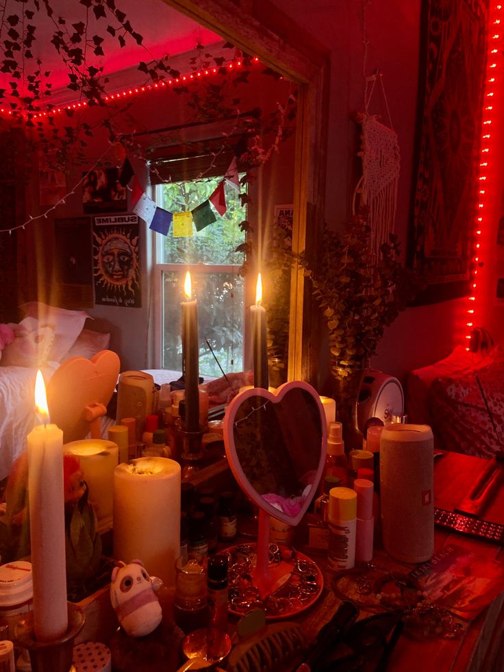 a table topped with candles next to a window filled with other decorations and decor items