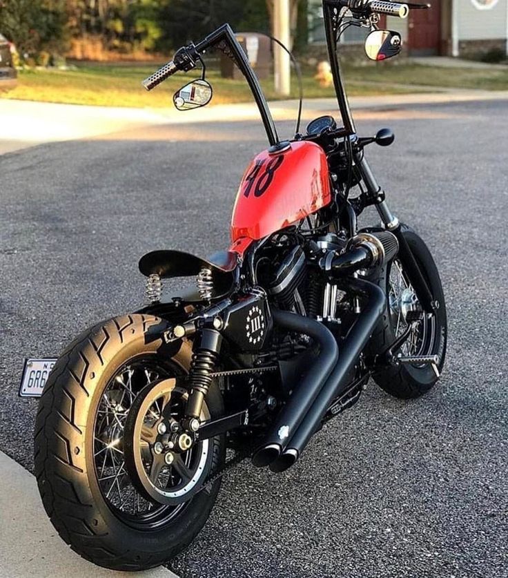 a red and black motorcycle parked on the street