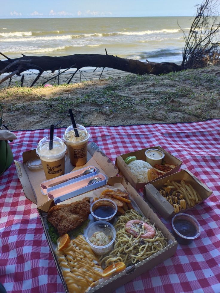 a picnic table with food and drinks on it