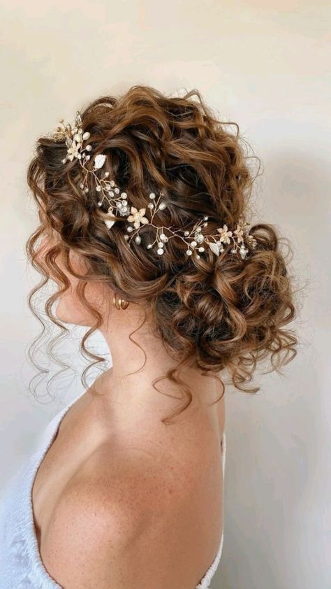 a woman with curly hair wearing a flowered headpiece