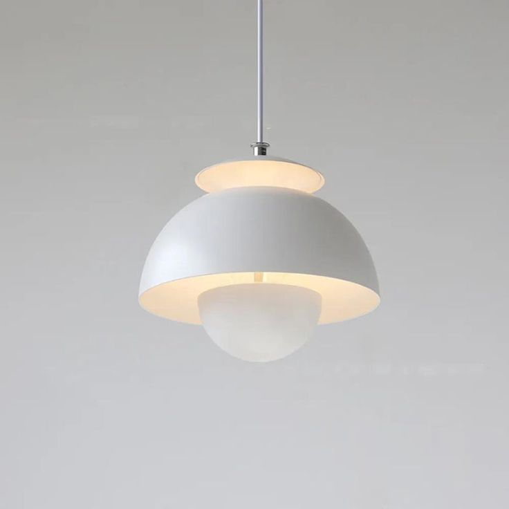 a white light hanging from a ceiling in a room with gray walls and flooring