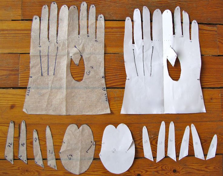 several pieces of paper cut out to look like gloves