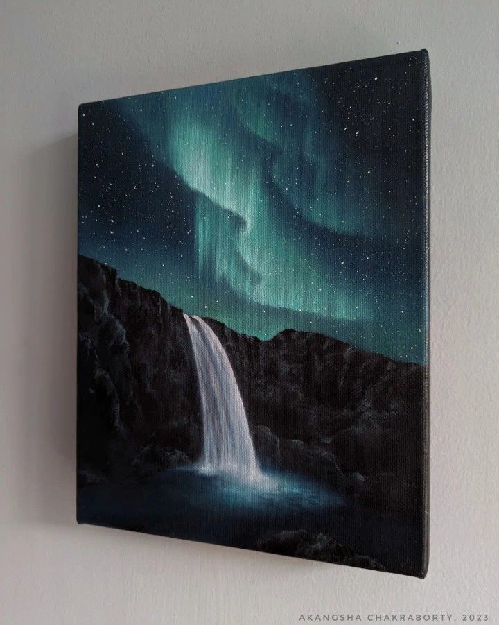 a painting of a waterfall with an aurora light in the sky above it on a wall