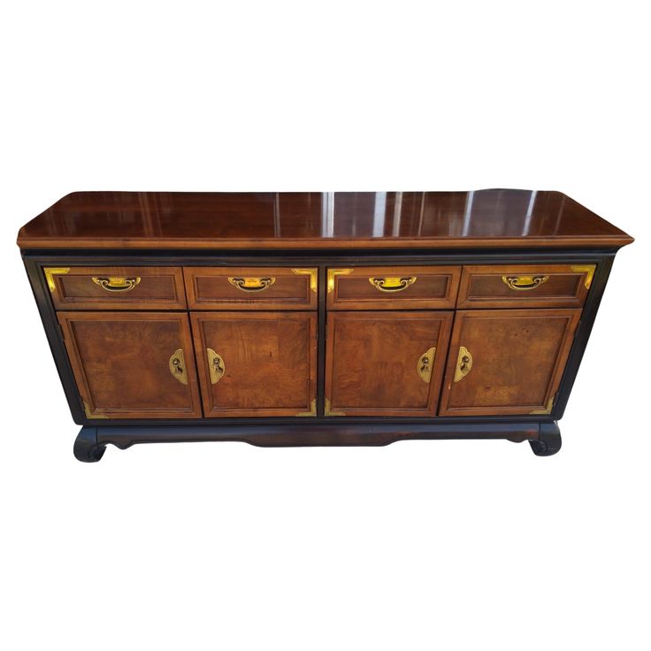 an old fashioned wooden cabinet with brass handles