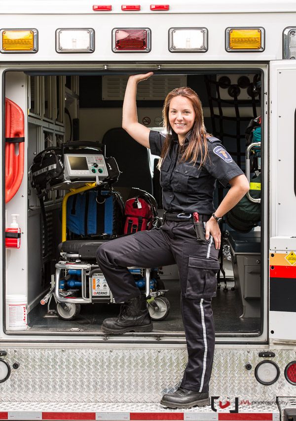 a woman standing in the back of a fire truck