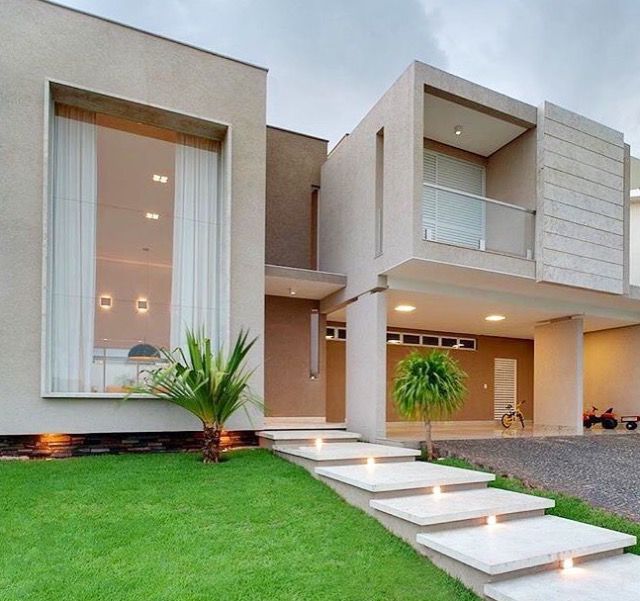 a modern house with steps leading to the front door