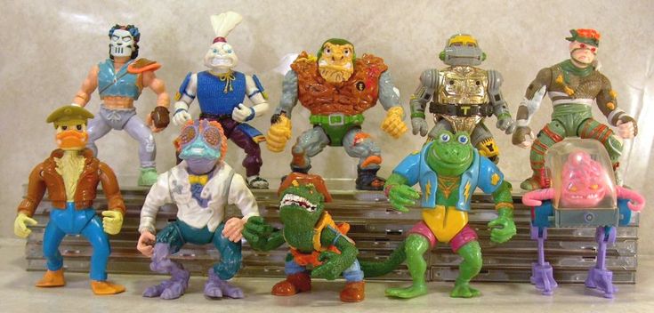 there are many toy action figures on the shelf together in this photo, including teenage mutant ninjas