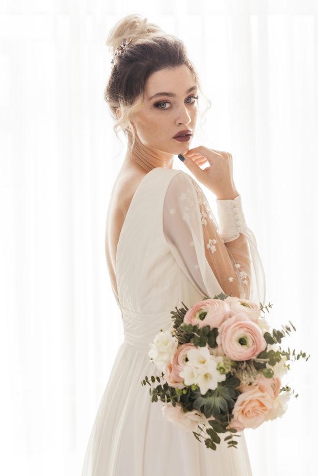 a woman in a wedding dress holding a bouquet