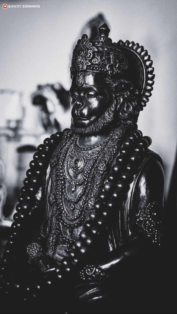 black and white photograph of a statue of a person wearing an elaborate headdress