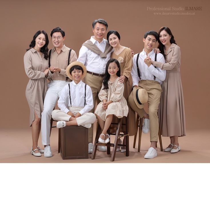 a group of people posing for a photo in front of a brown background with white shoes