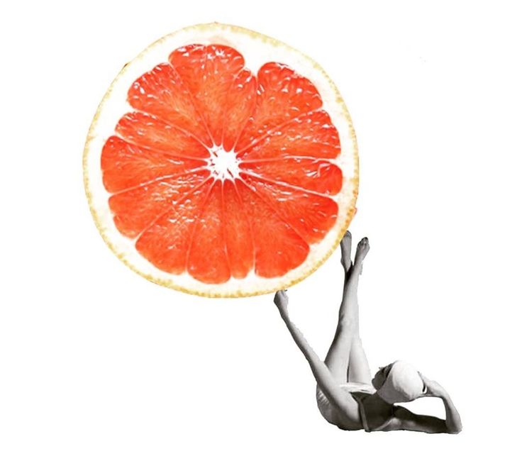 a woman is holding up a large grapefruit in front of her face as she dives into the water