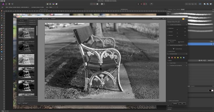 a black and white photo of a bench