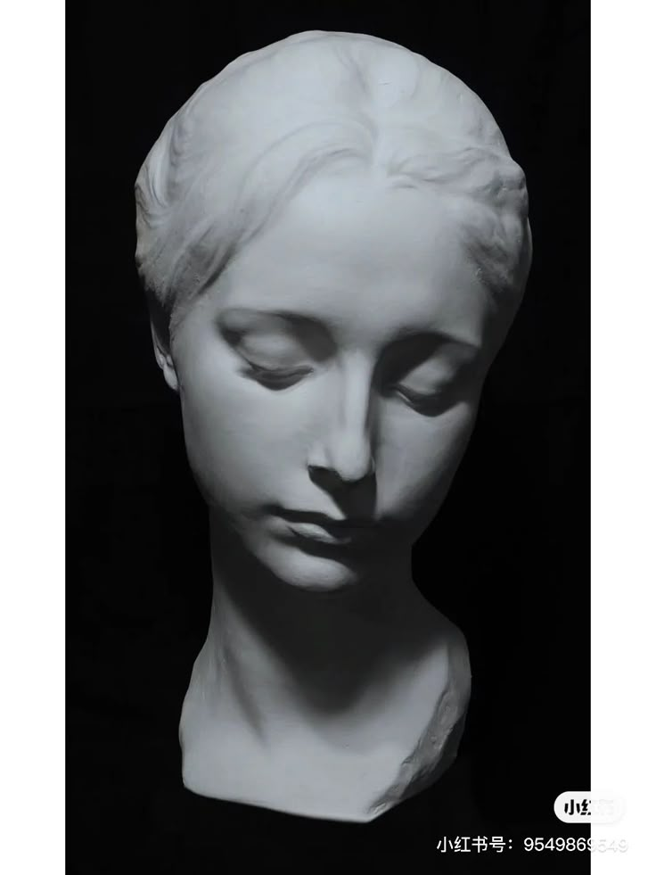 a black and white photo of a bust of a woman's head with her eyes closed