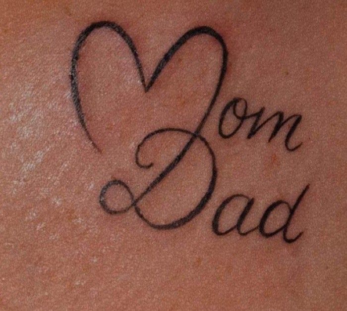 a woman's back with the words son and dad written on it