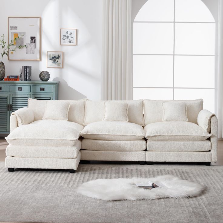 a living room with a white couch and rug