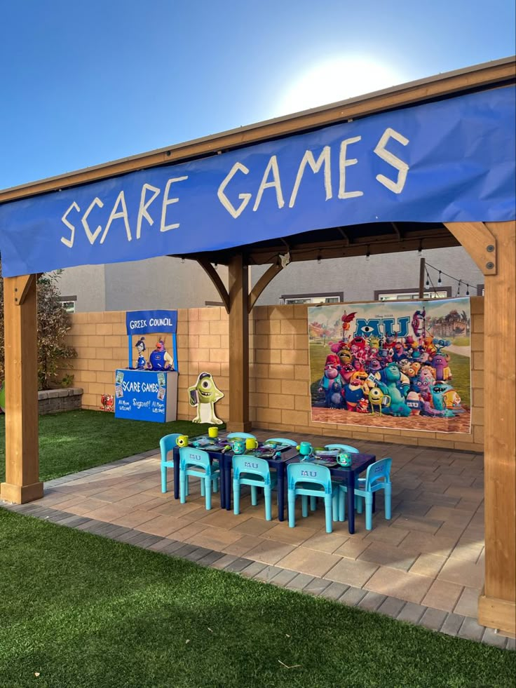 an outdoor area with tables and chairs under a blue sign that says scare games on it