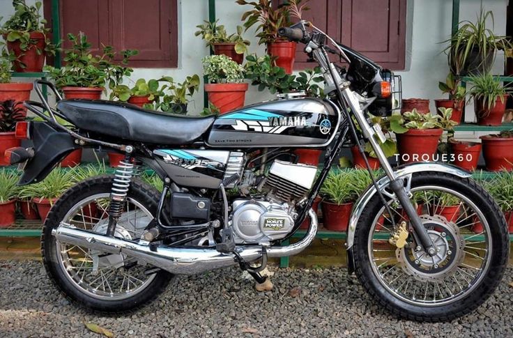 a motorcycle parked in front of some potted plants