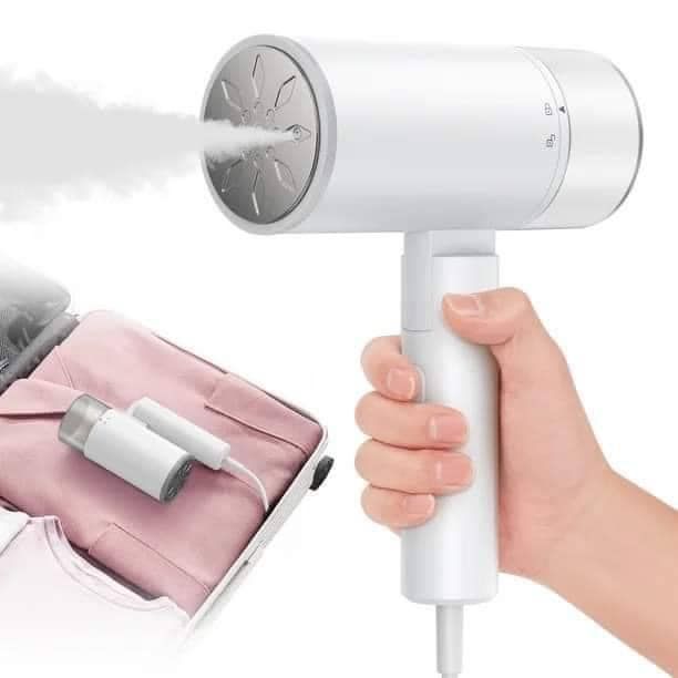 a person is holding a hair dryer in their hand and spraying it with steam