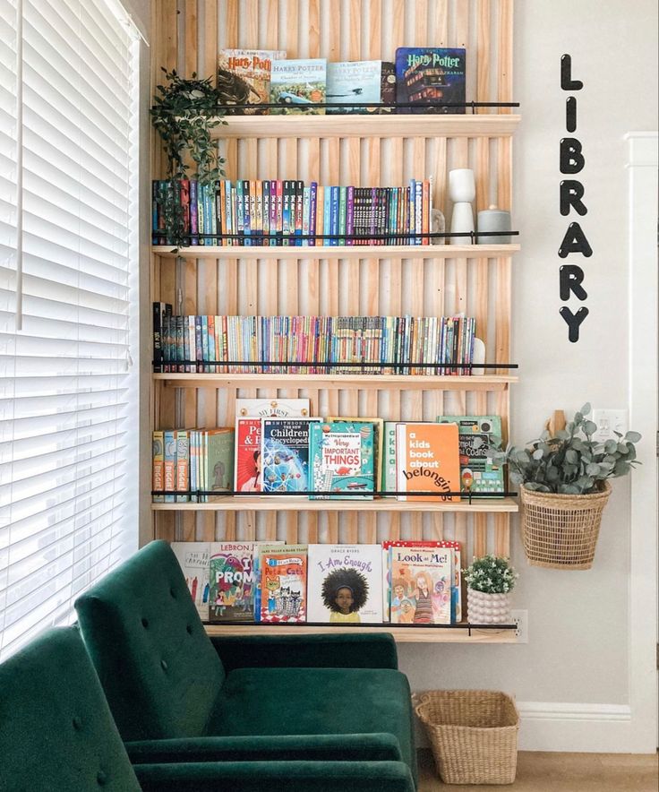 a green couch sitting in front of a book shelf filled with books