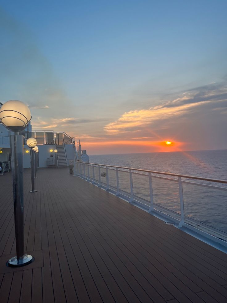 the sun is setting over the ocean on a cruise ship