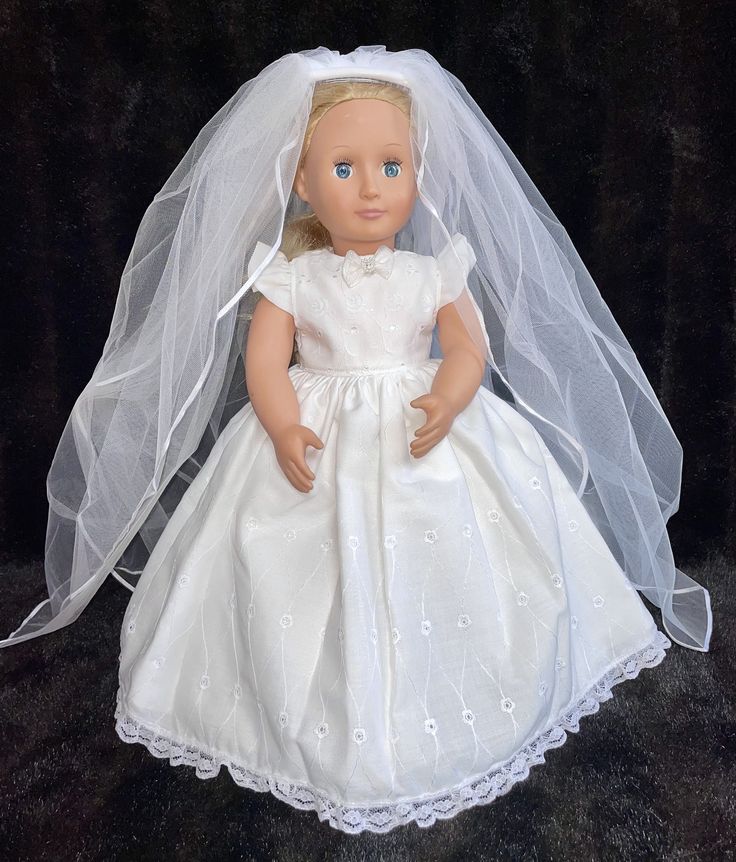 a doll wearing a wedding dress and veil