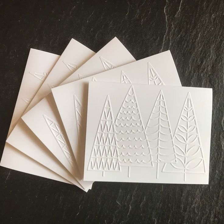 five white cards with trees on them